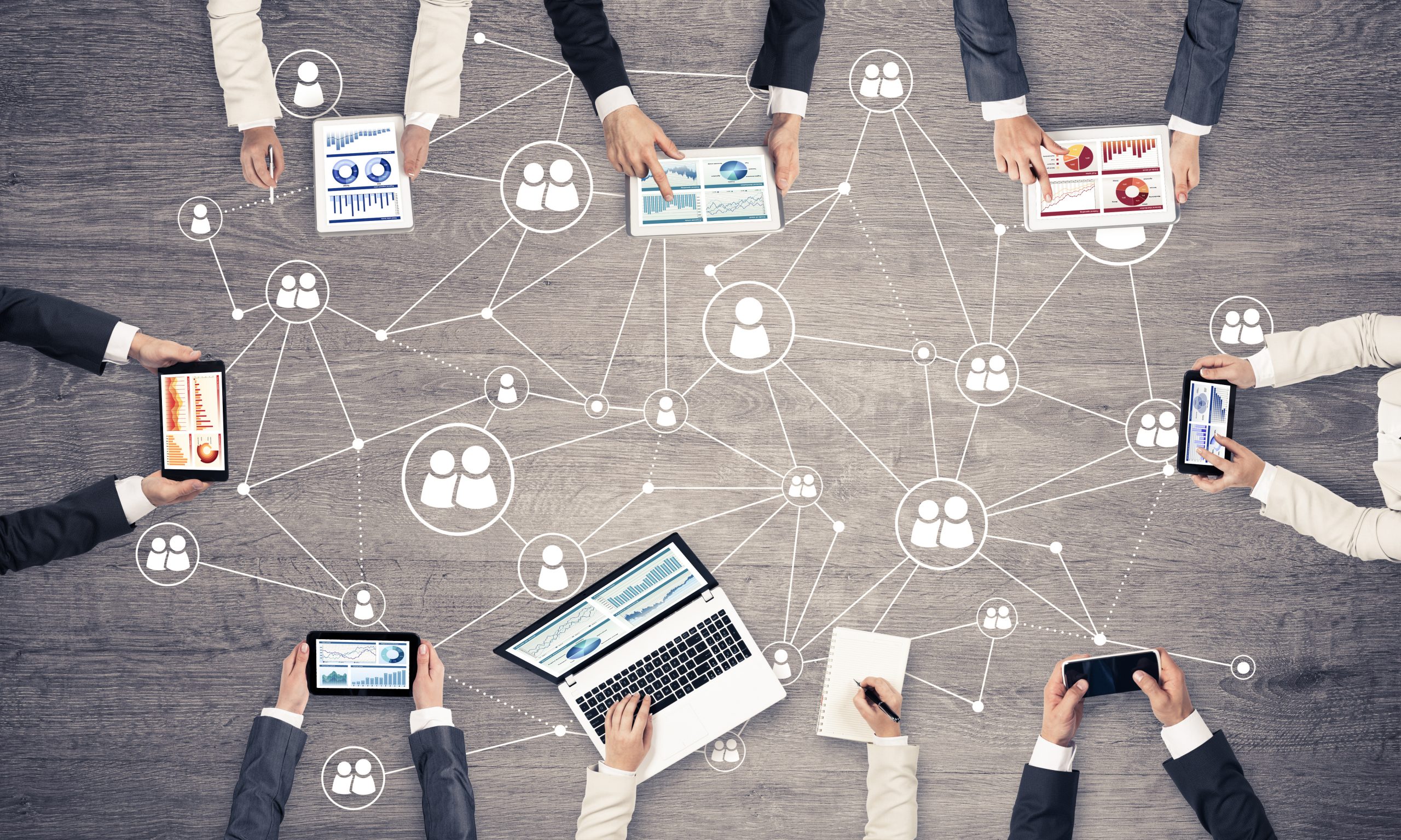 Group,Of,People,With,Devices,In,Hands,Working,Together,As